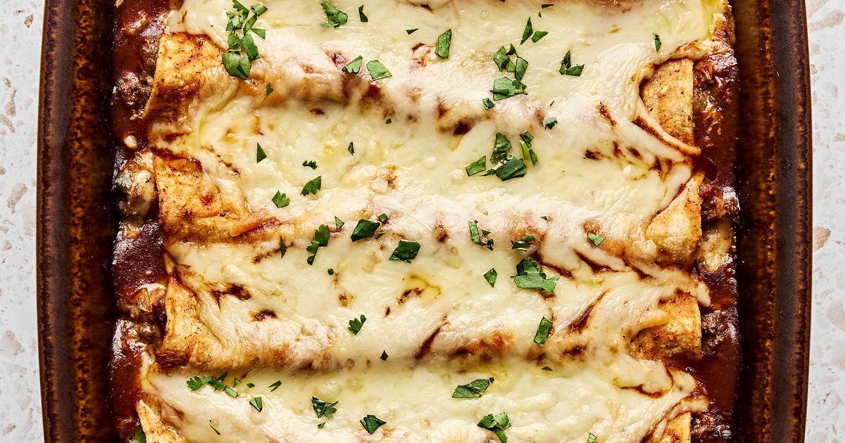 Red beef enchiladas baked with melted cheese, red sauce, and cilantro